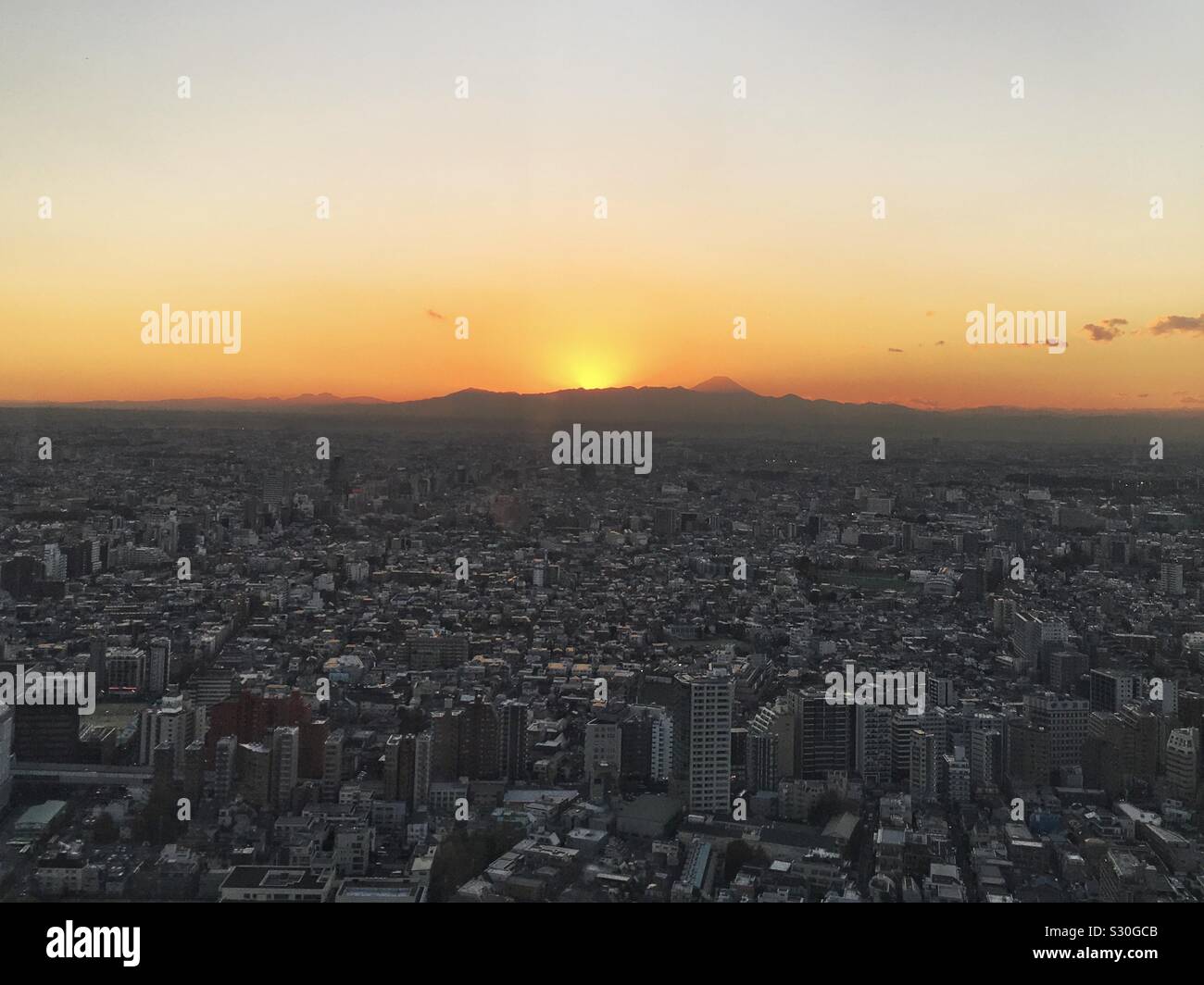 Sunset and Mt. Fuji from the west tower observation deck of the Tokyo Metropolitan Government Building Stock Photo