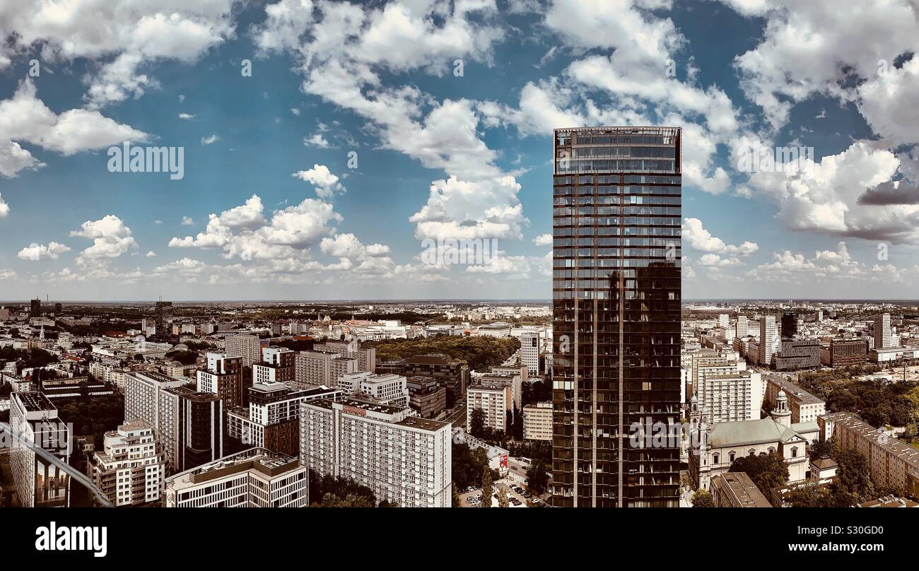 High rise office building with clouds and blue sky behind Stock Photo
