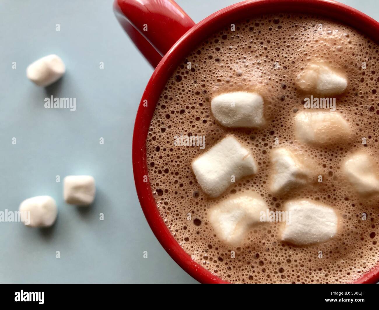 Top down view of hot cocoa and marshmallows in a red mug - Smartphone Captured Stock Image