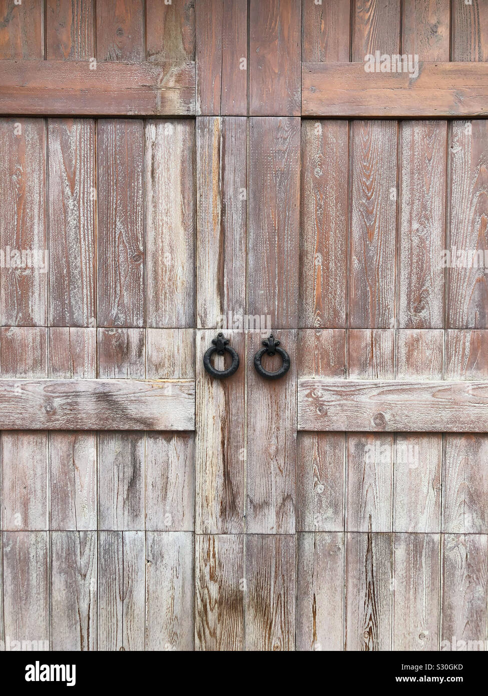 Iron door handles on barn door Stock Photo