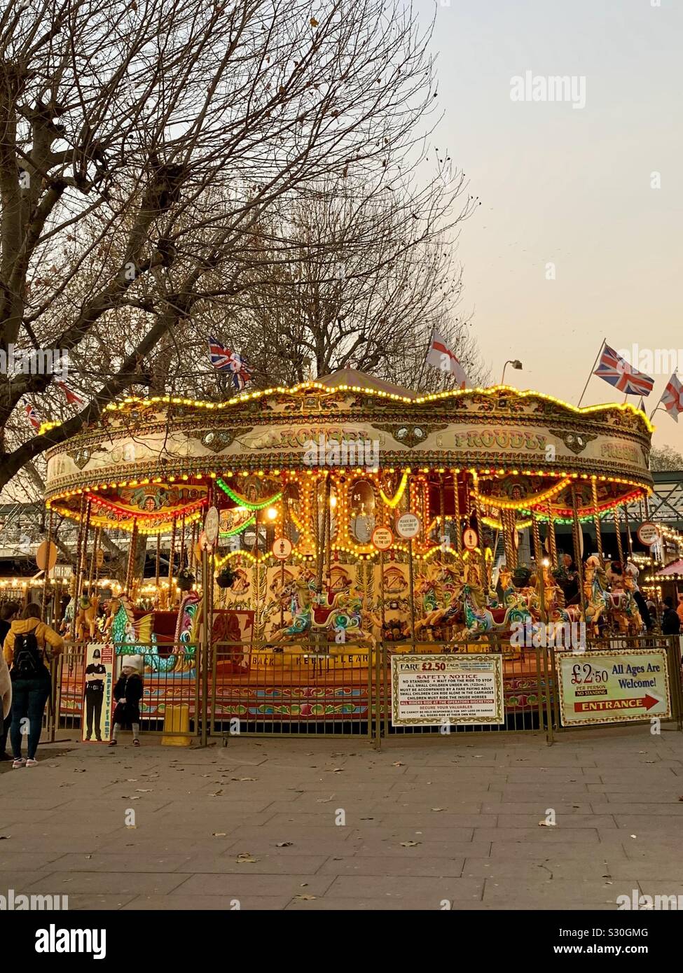 London, UK - 2 December 2019: A carousel on the south bank of the River Thames. - Smartphone Captured Stock Image