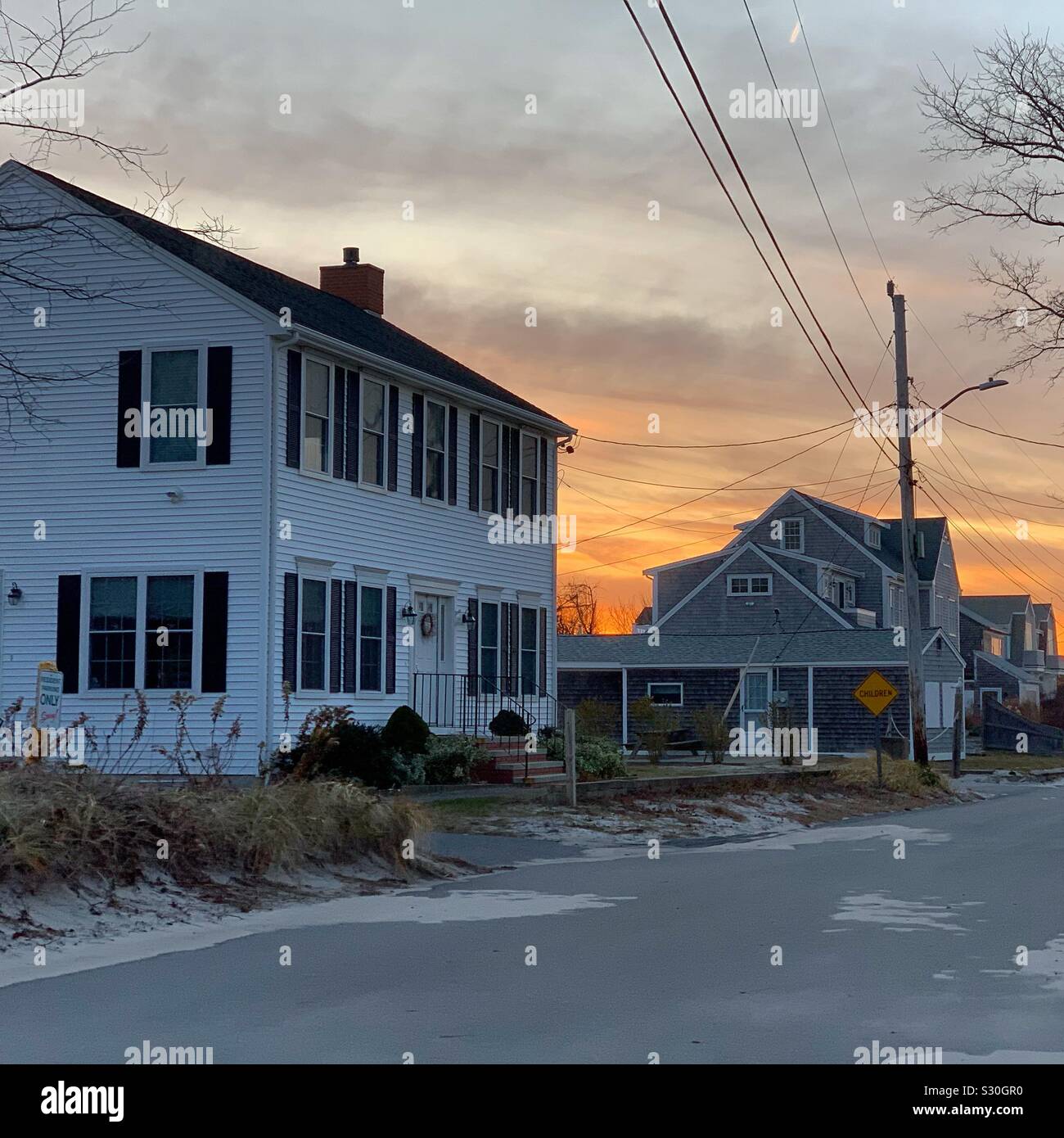 November sunset on a street by Mayflower Beach, Dennis, Cape Cod, Massachusetts, United States - Smartphone Captured Stock Image