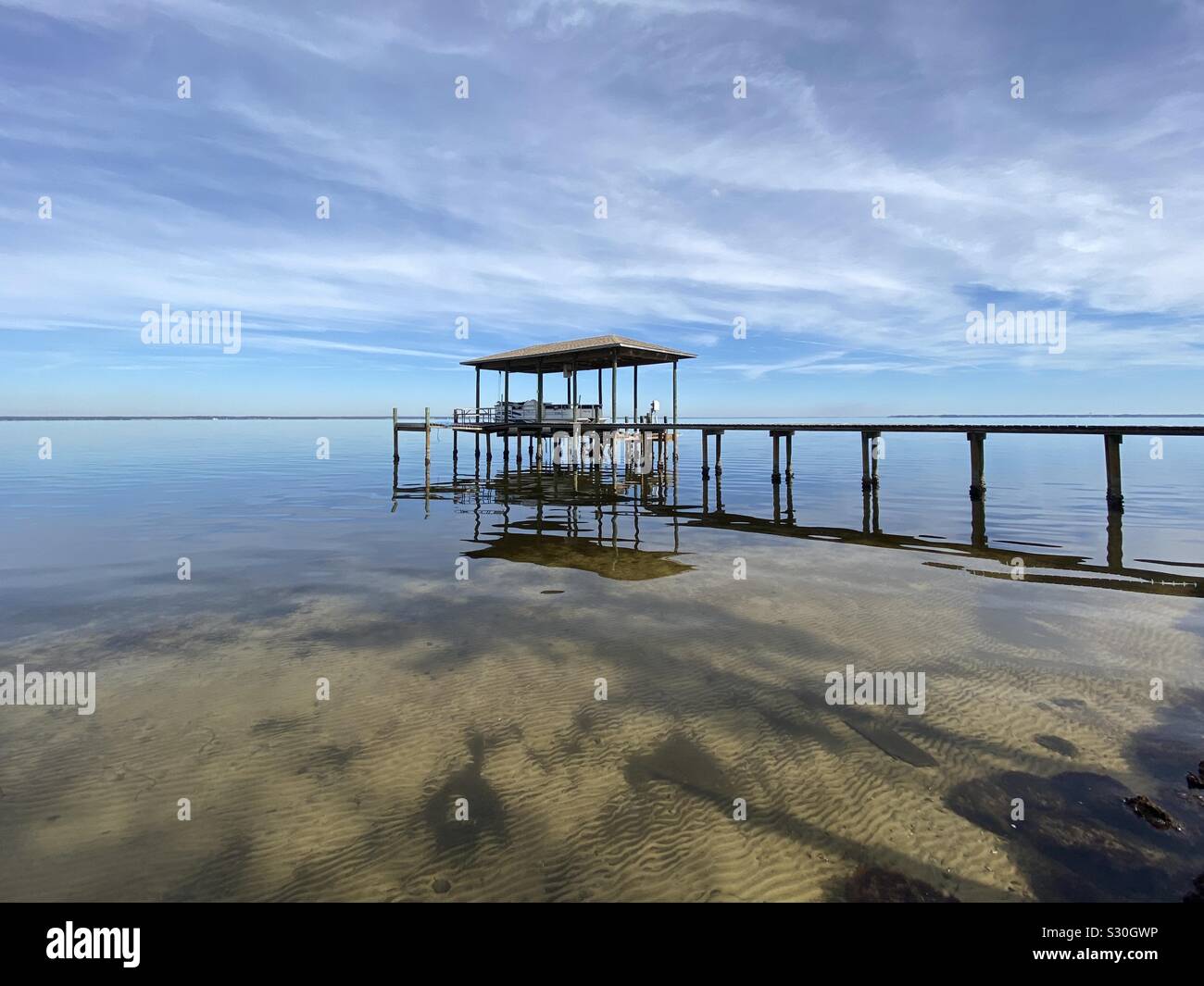 Perspective photography of boat dock on calm bay water - Smartphone Captured Stock Image