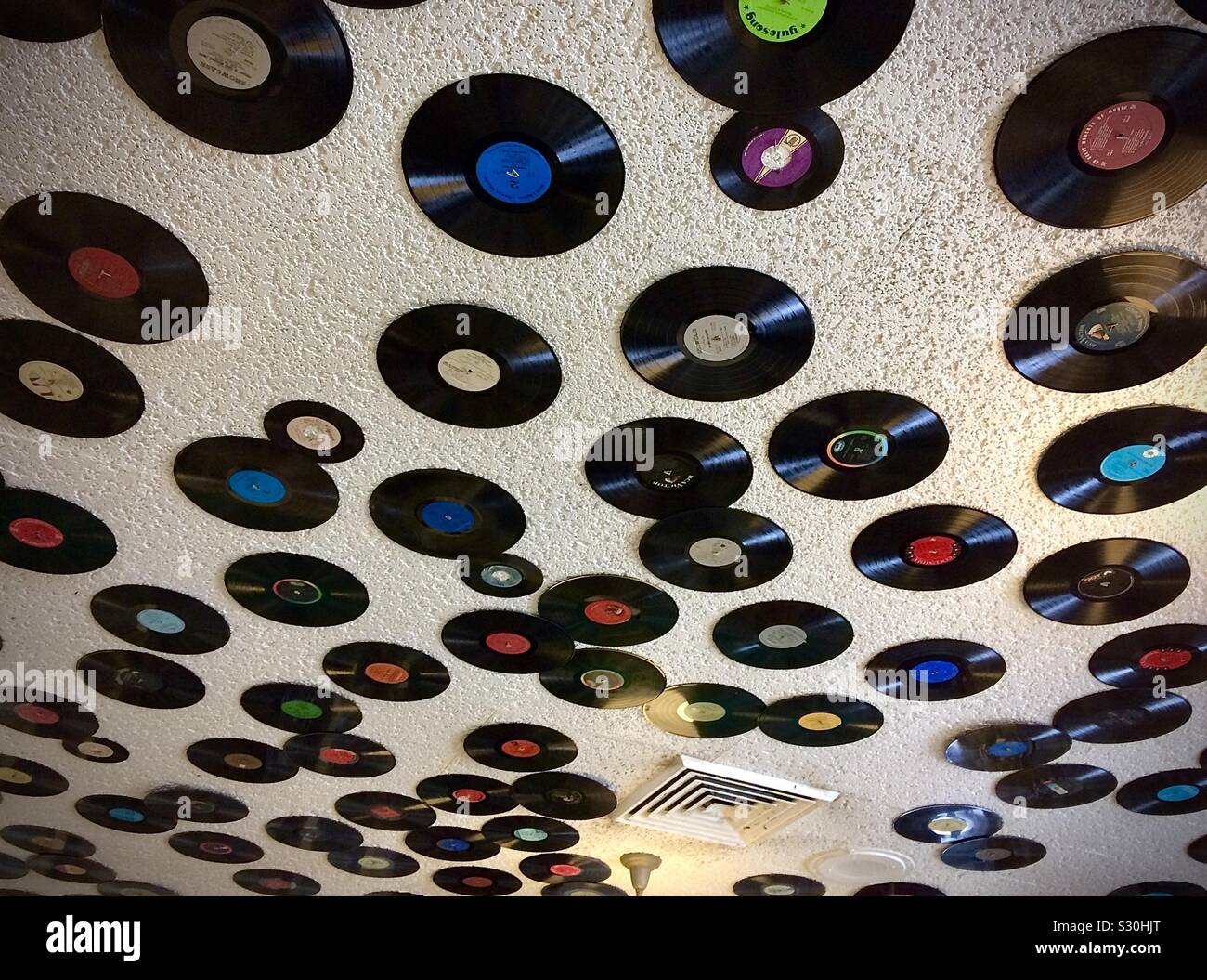 Old records attached to ceiling of restaurant in Manistee, Michigan, USA. Stock Photo