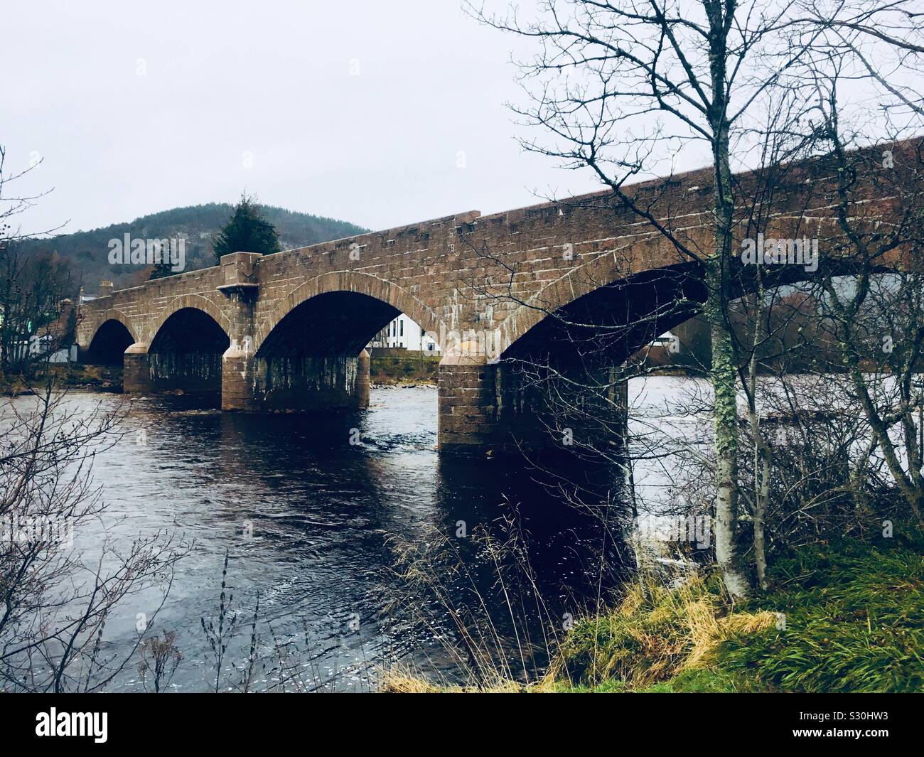 Royal Bridge, Ballater over the River Dee. Also known as Ballater Bridge or Queen's Bridge. The bridge was opened in 1885 by Queen Victoria. Stock Photo