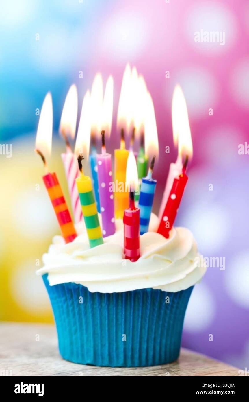 Birthday cake with candles. Cupcake with lots of burning candles and decorative frosting Stock