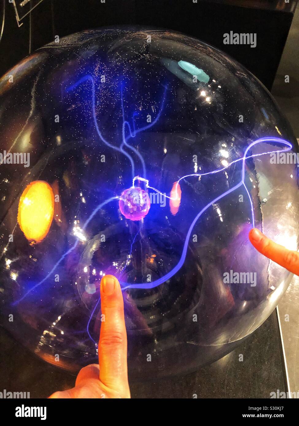 Two Fingers Touching A Plasma Ball Stock Photo Alamy