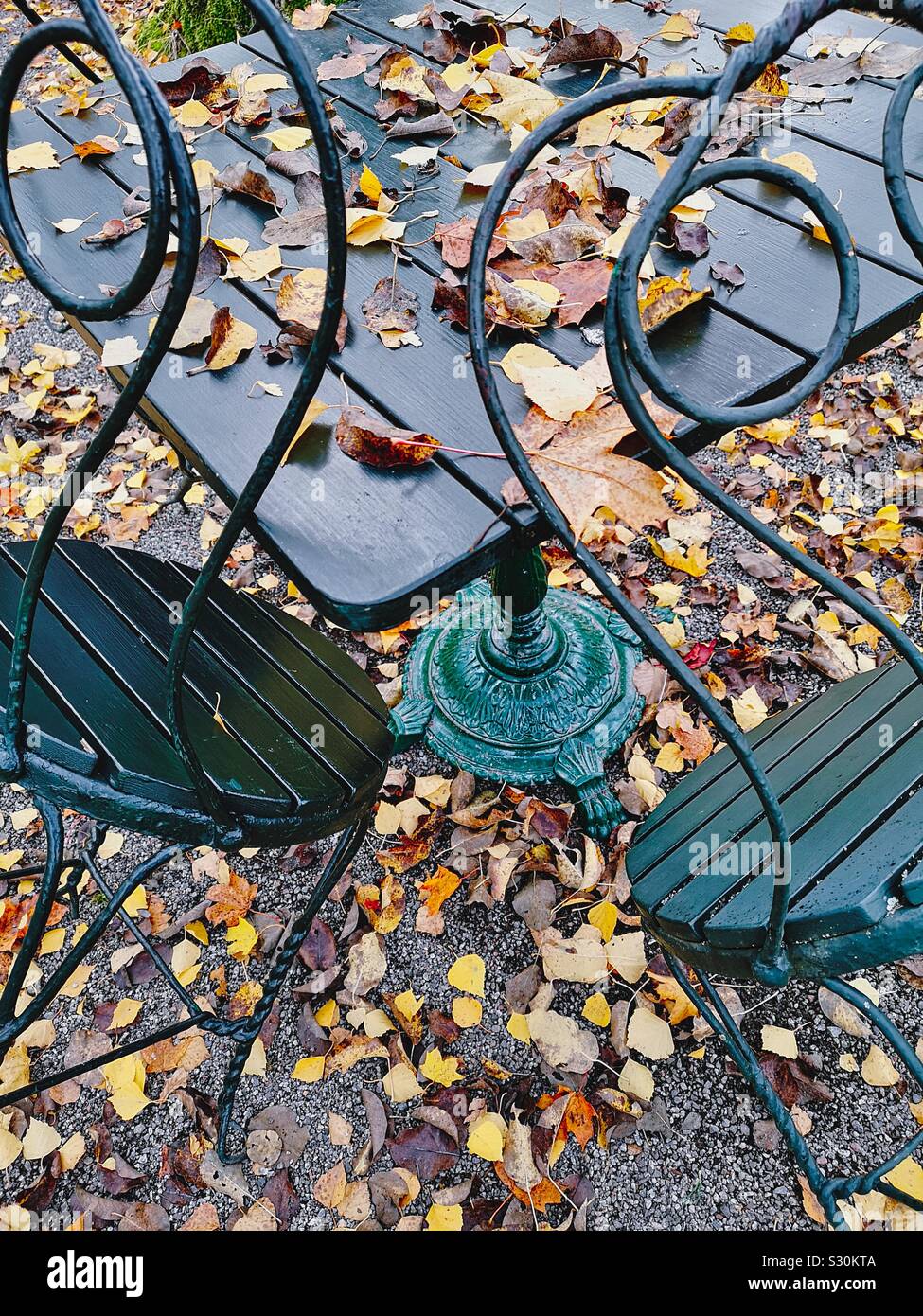 French style Outdoor cafe table and chairs amongst autumn leaves, Stockholm Stock Photo