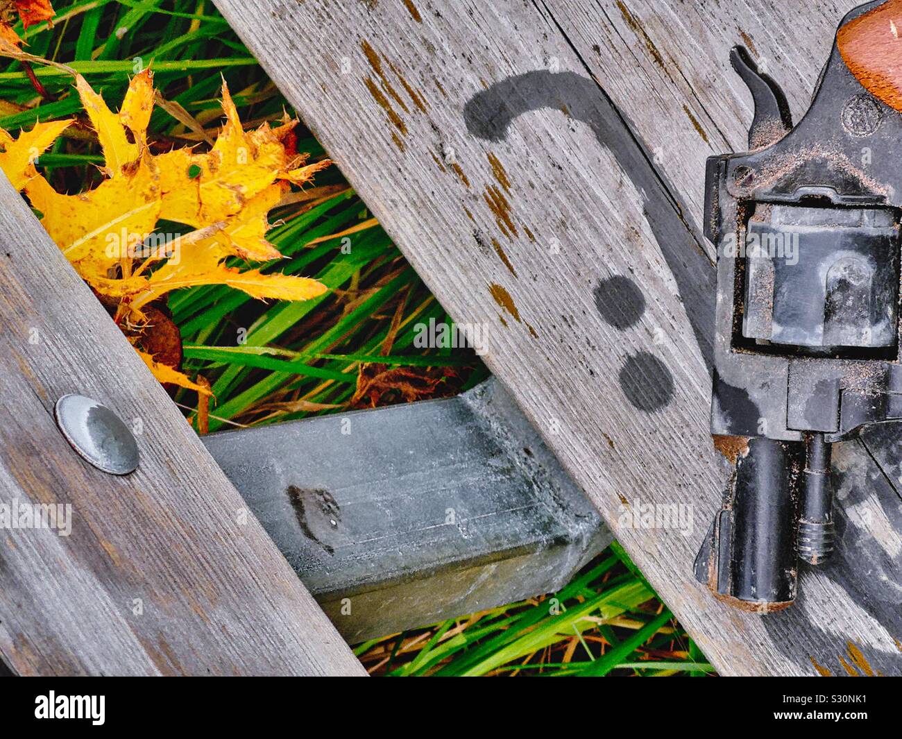 Gun abandoned discarded on outdoor seat Stock Photo