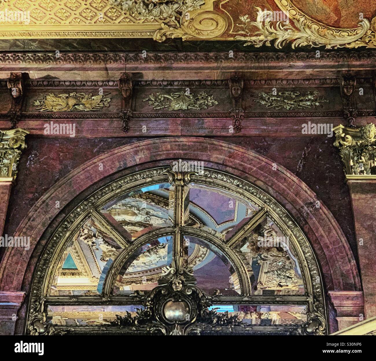 Red marble and gold accents among the ornate details of the dining room at Marble House, Newport, Rhode Island, United States - Smartphone Captured Stock Image