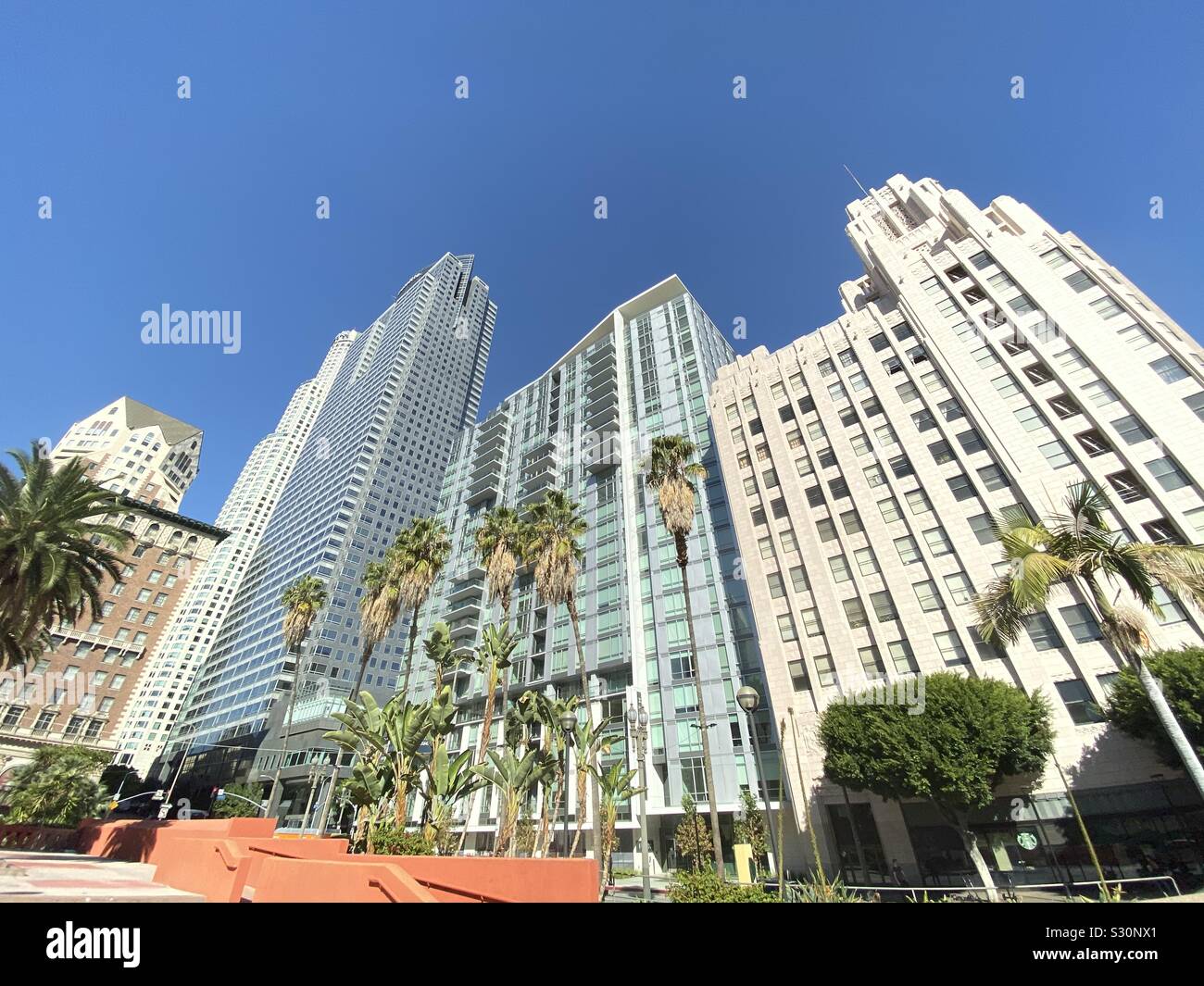 LOS ANGELES, CA, NOV 2019: wide view, looking up at apartment buildings next to office skyscrapers in Downtown near Pershing Square - Smartphone Captured Stock Image