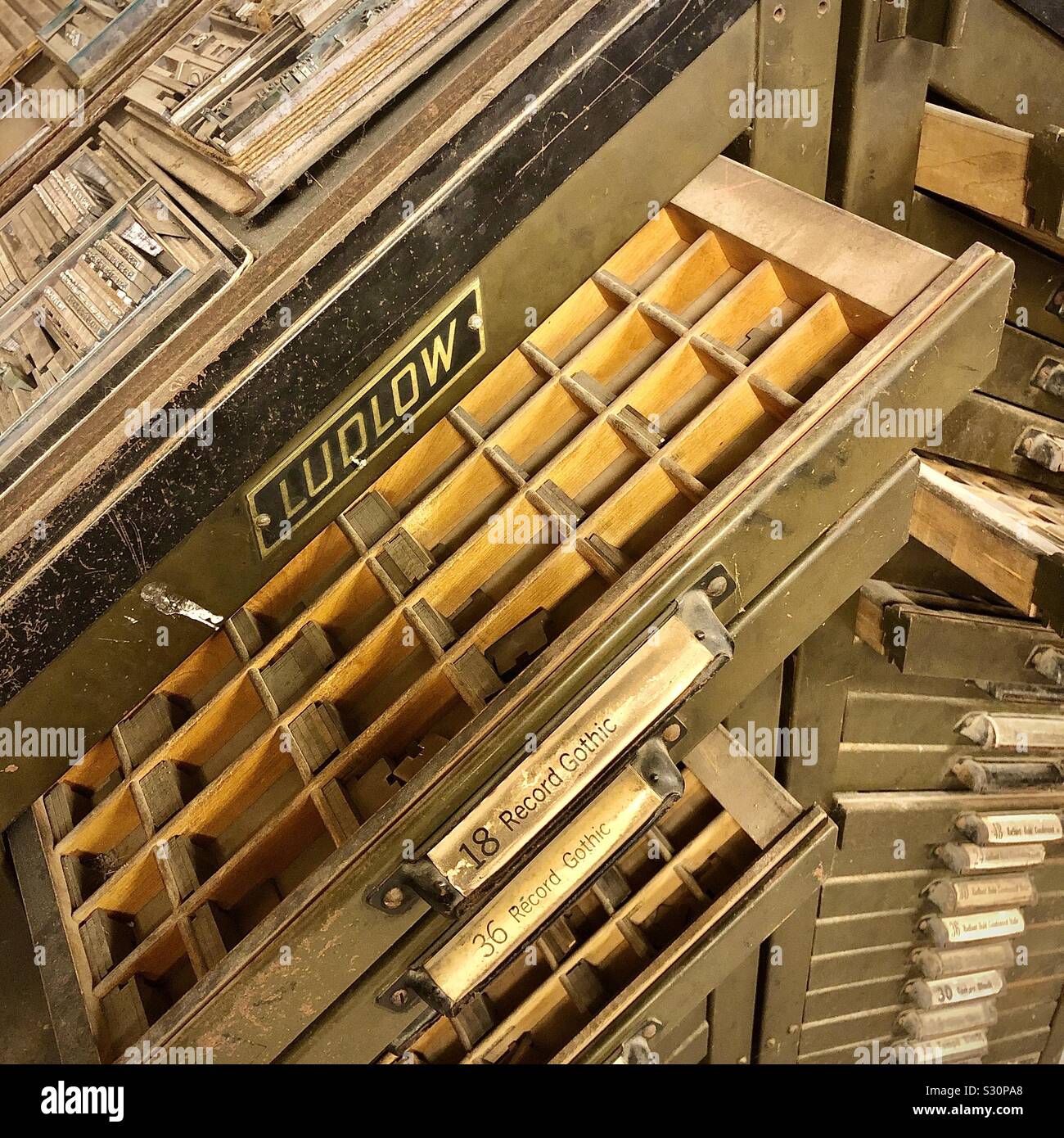 Old printers metal type drawers. Stock Photo