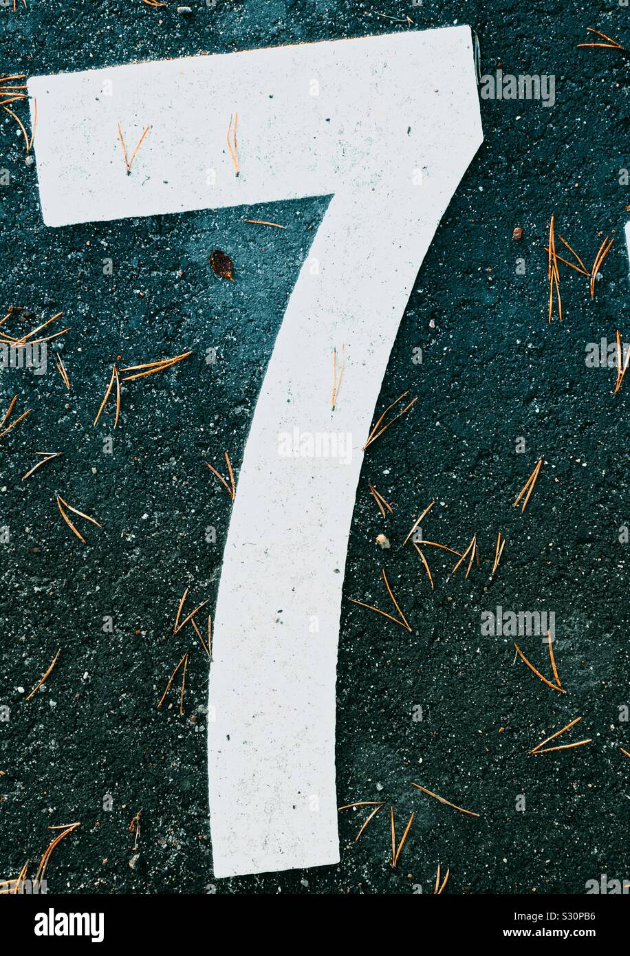 Giant white oversized number seven on ground Stock Photo