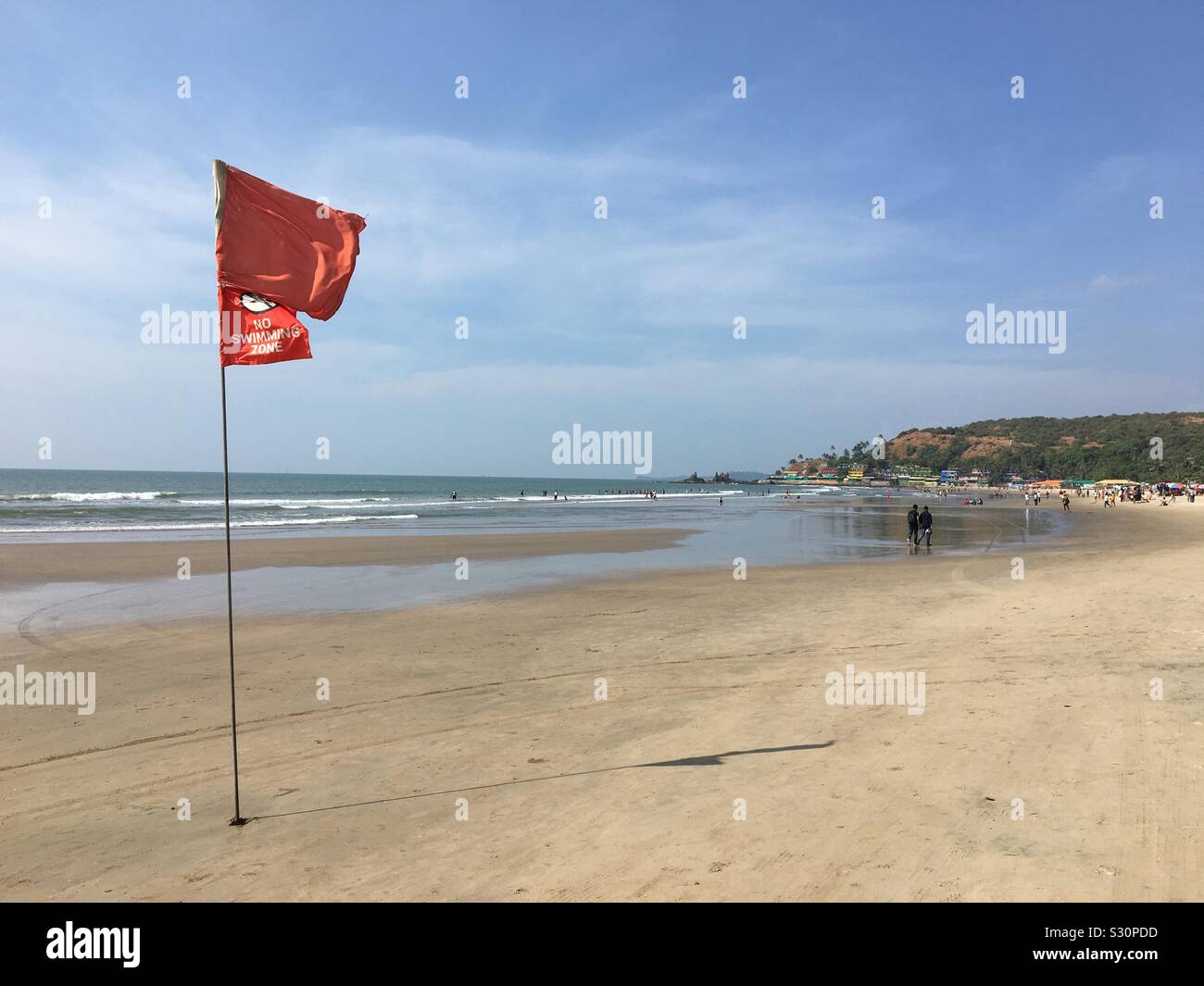 Flag that warns for swimming in on a tropical beach Stock Photo