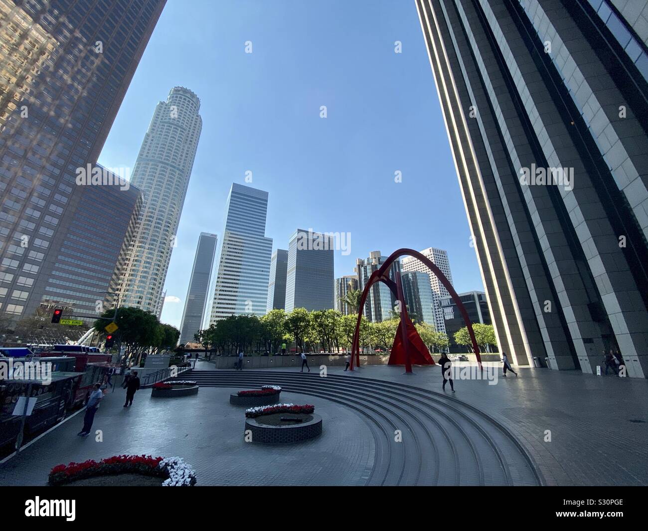 LOS ANGELES, CA, NOV 2019: wide angle view of outdoor plaza with people walking in the Financial District of Downtown, skyscrapers in background - Smartphone Captured Stock Image
