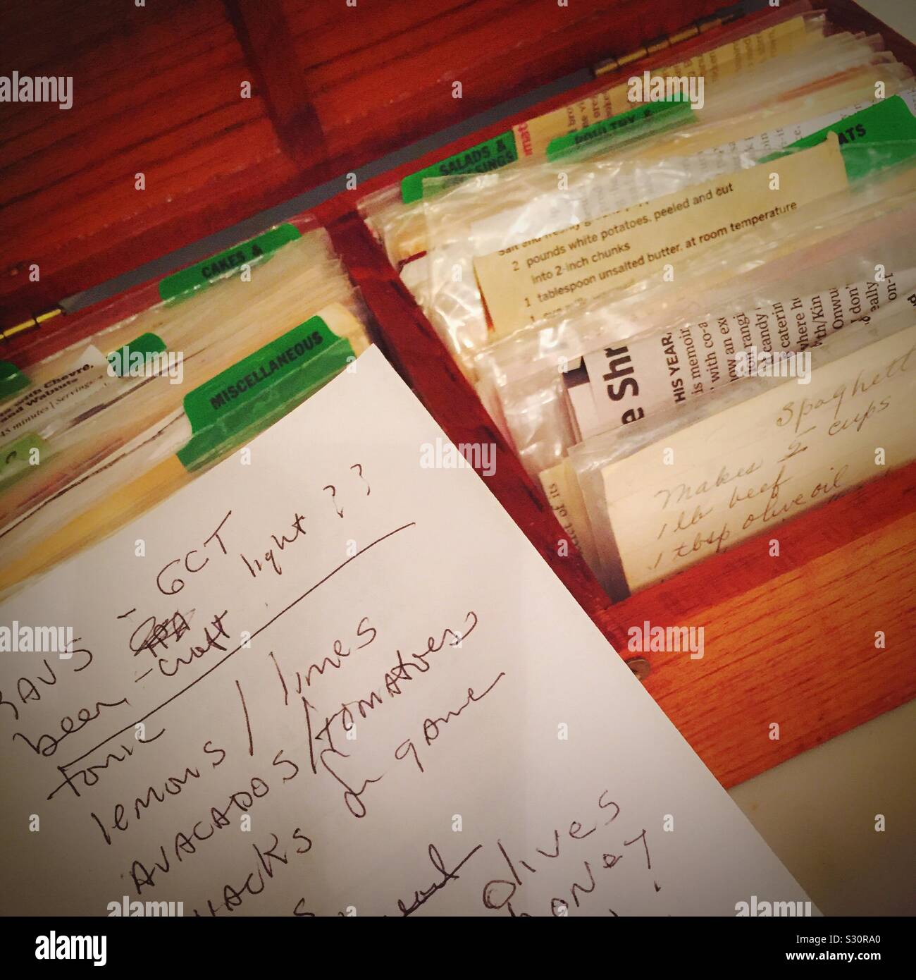Handwritten shopping list and recipe box in a residential kitchen,USA Stock Photo