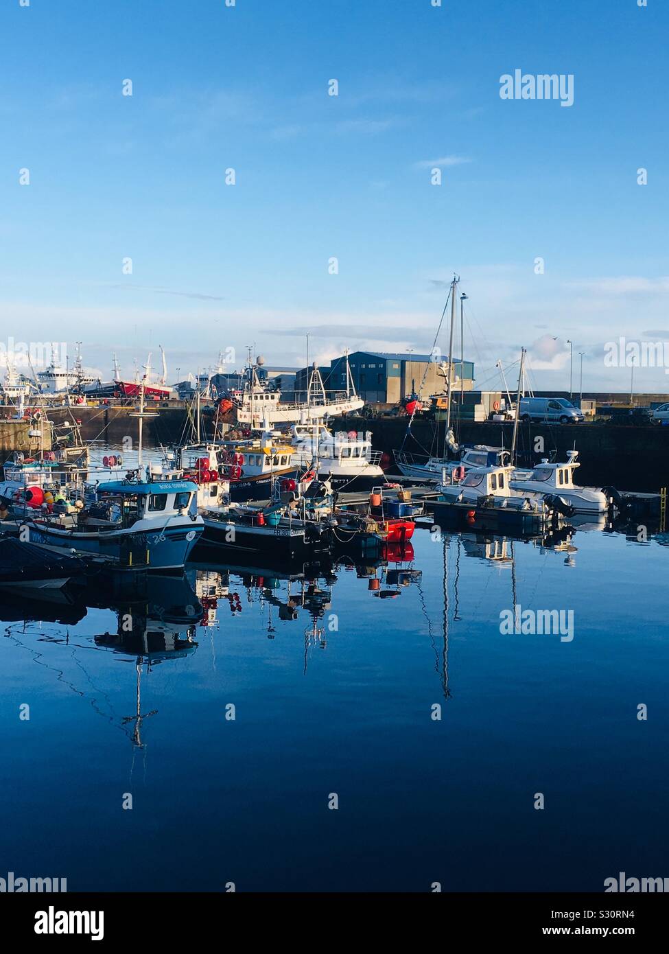 A line of Fishing Boats moored in Fraserburgh Harbour, Scotland Stock Photo