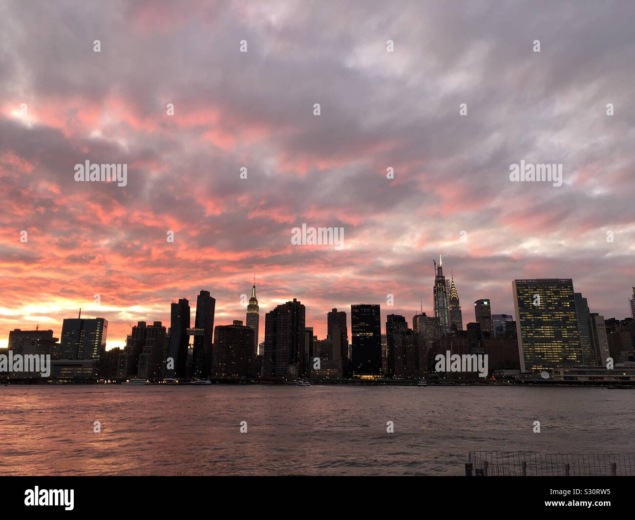 Midtown Manhattan view from the East River at Sunset Stock Photo