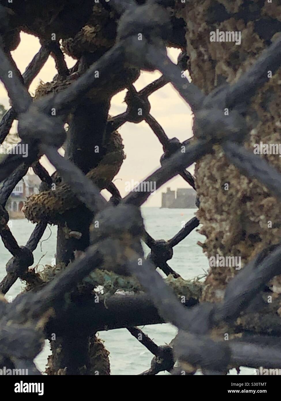 Dartmouth Castle through a crab pot Stock Photo