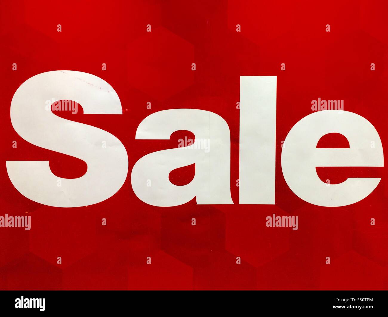 Paper poster of large white letters SALE on red background as contrast composition - Smartphone Captured Stock Image