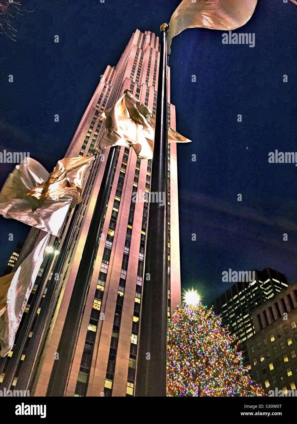 The iconic Christmas tree is at the base of the skyscraper 30 rock, NYC, USA Stock Photo