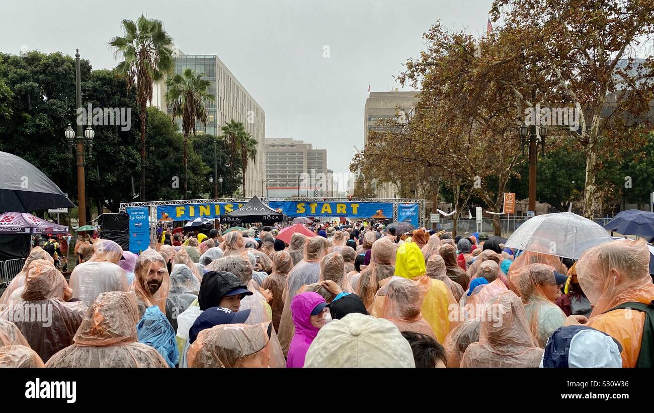 LOS ANGELES, CA, NOV 2019: runners in rain coats line up for the start of the annual Turkey Trot 5K race on Thanksgiving in Downtown - Smartphone Captured Stock Image