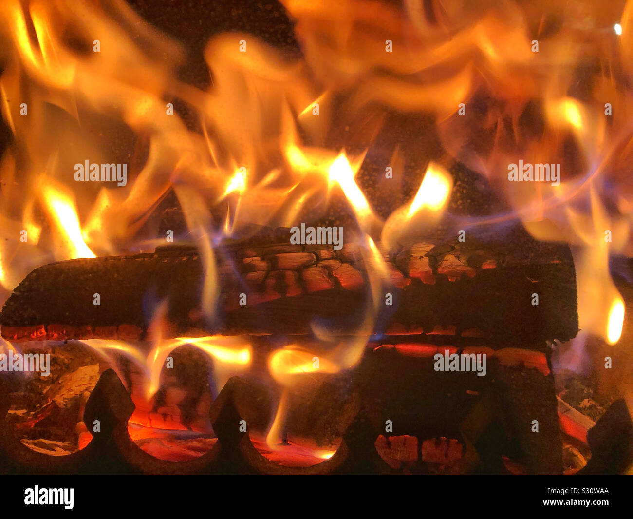 Burning logs on a Woodburner - Smartphone Captured Stock Image