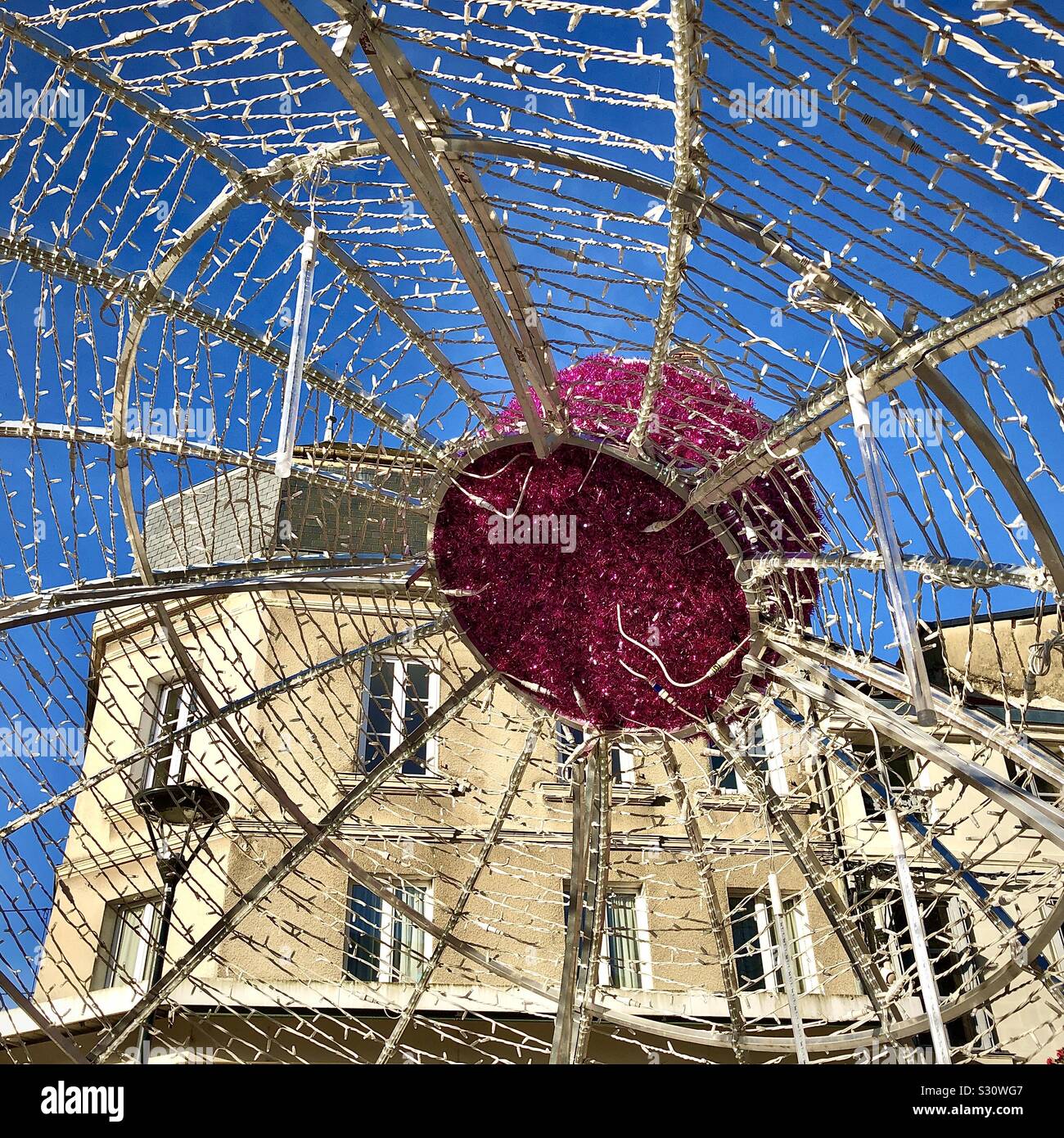 View from underneath large Christmas bauble in city center - Chatellerault, Vienne, France. Stock Photo