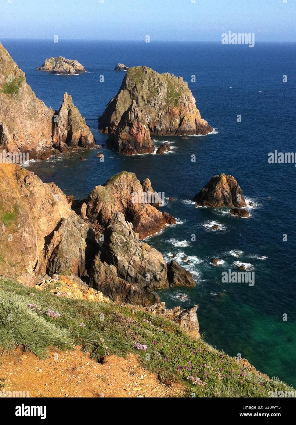 Spectacular rocky coastline at Telegraph Hill on Alderney, third-biggest of the British Channel Islands. Stock Photo