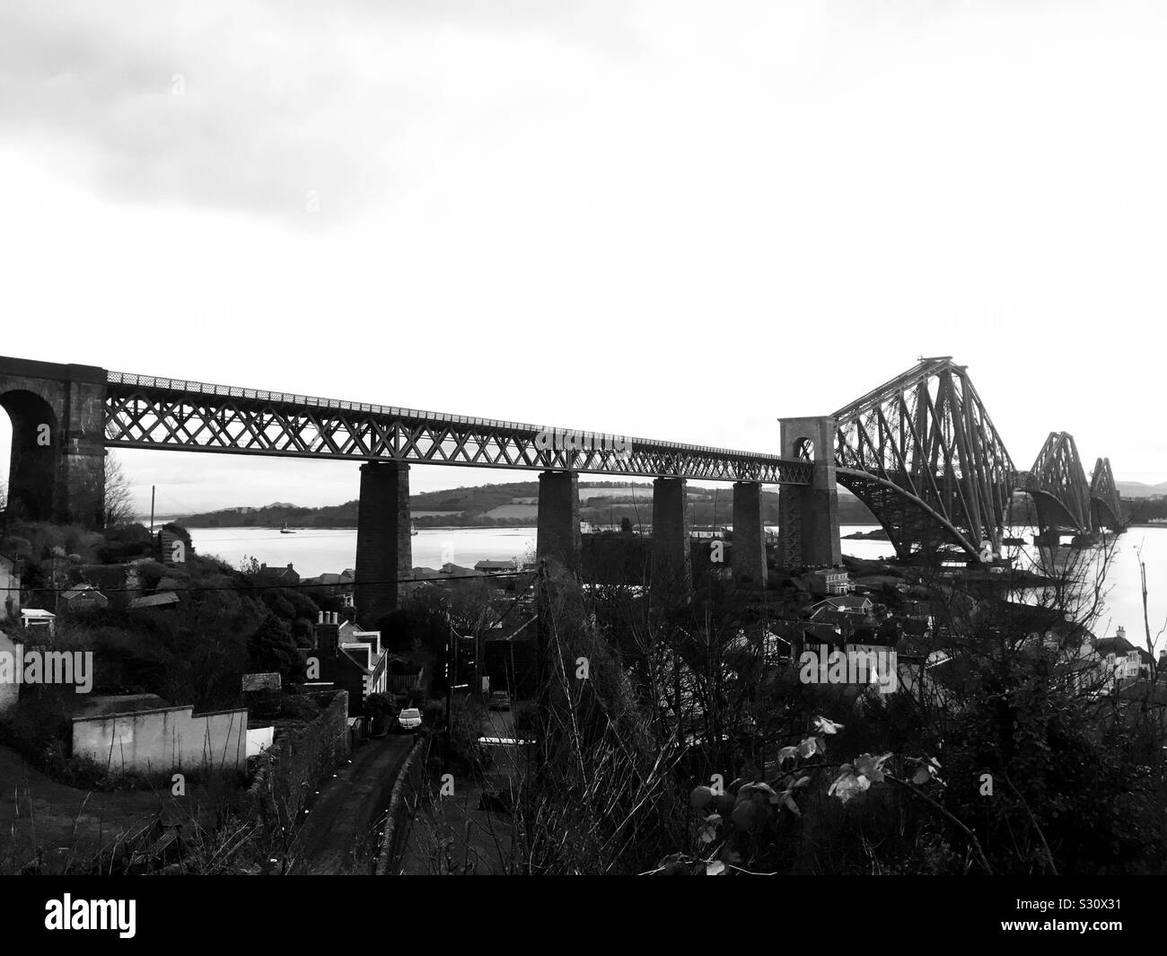 The Forth Rail Bridge over the Firth of Forth, in monochrome, viewed from North Queensferry, Scotland Stock Photo