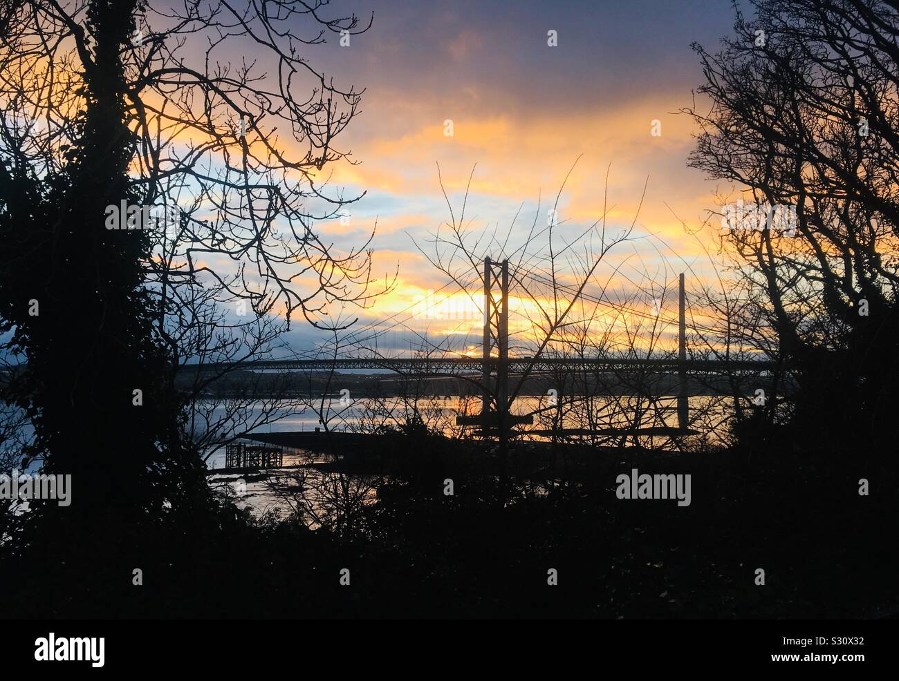 Sunset over the Forth Road Bridge over the Firth of Forth, viewed from North Queensferry, Scotland Stock Photo