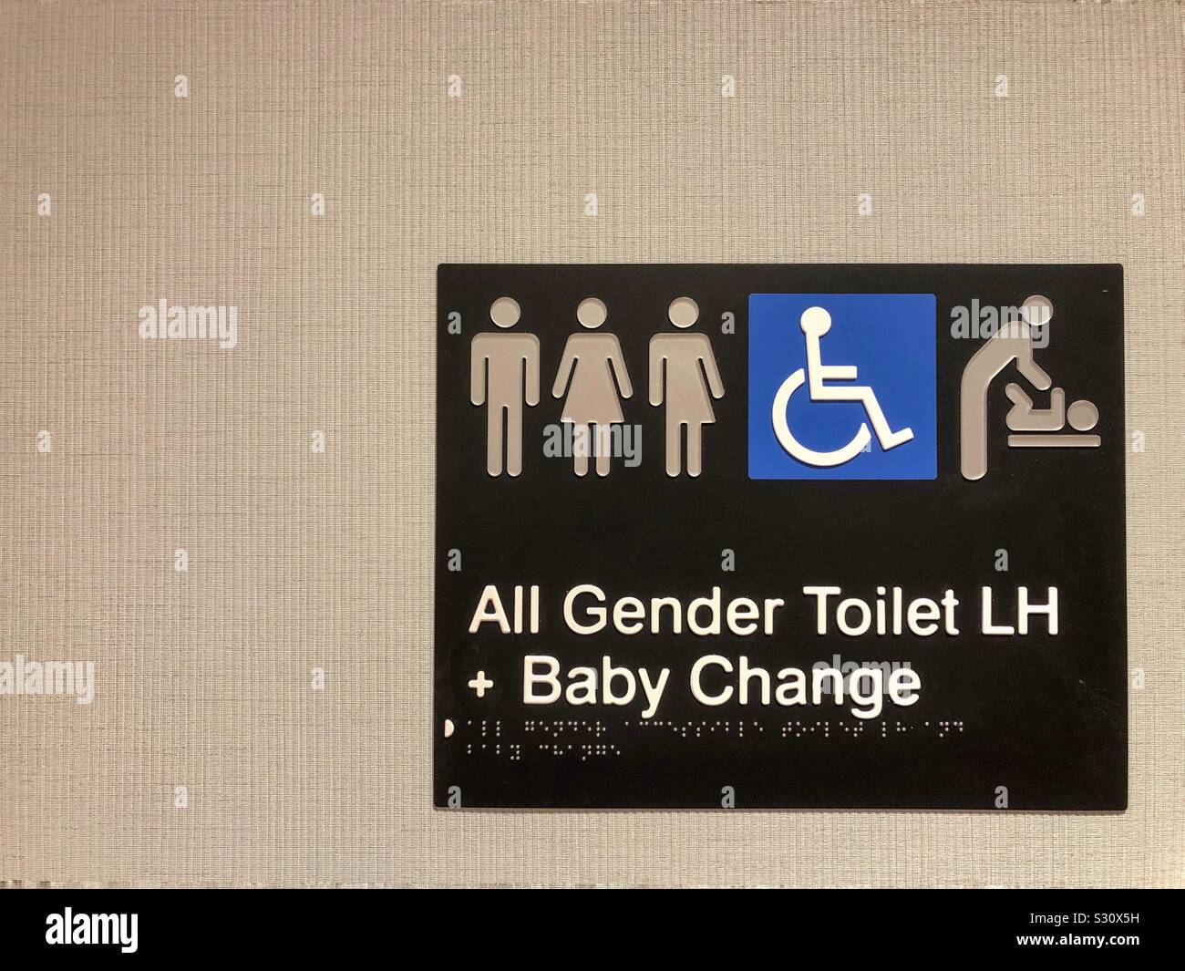 All gender toilet and baby change room sign. - Smartphone Captured Stock Image