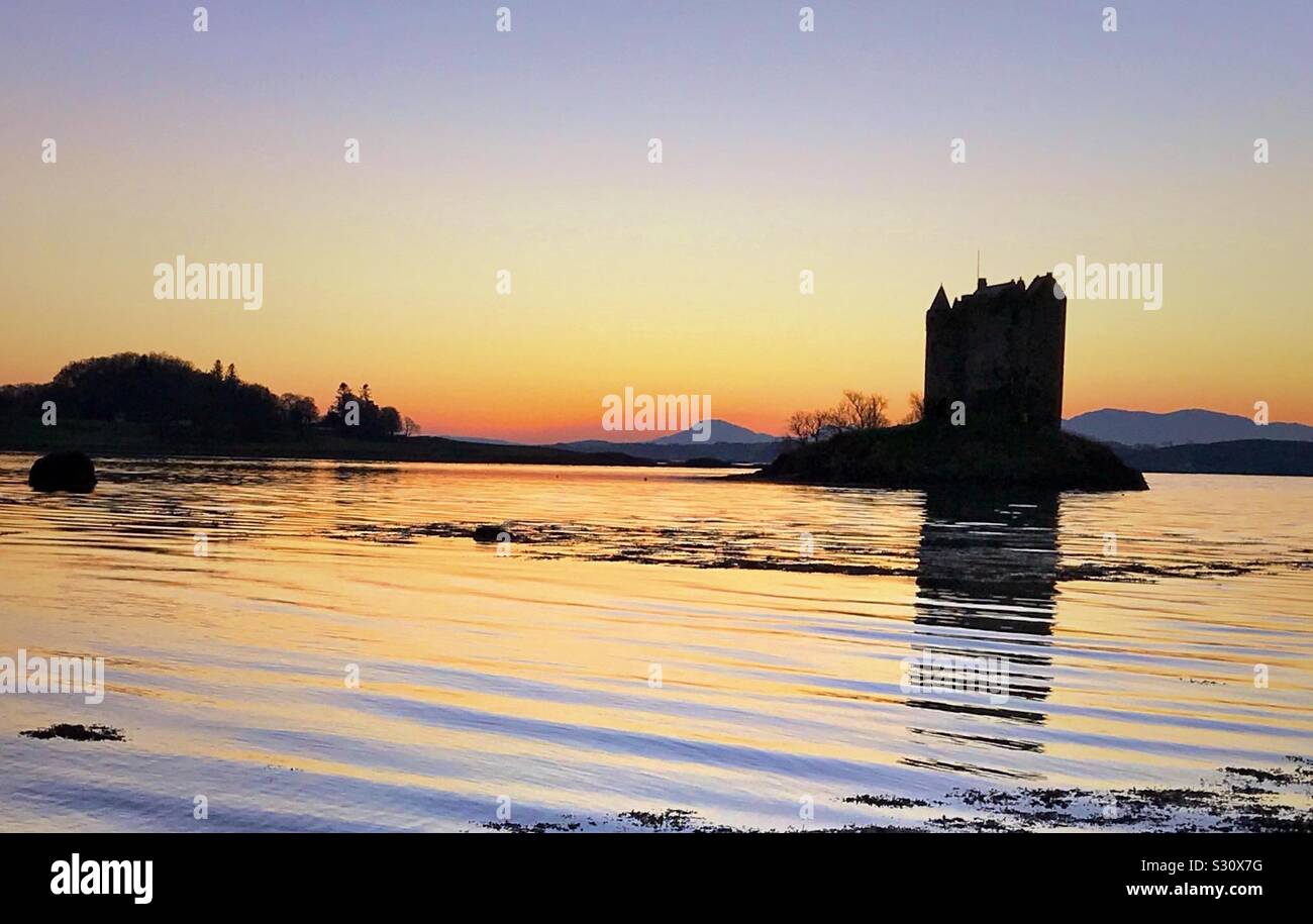 Sunset behind Castle Stalker on the west coast of Scotland. - Smartphone Captured Stock Image