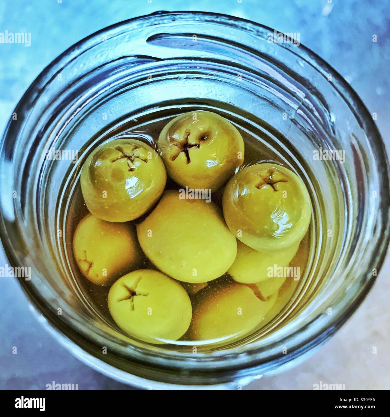 Top view of green olives in glass jar Stock Photo