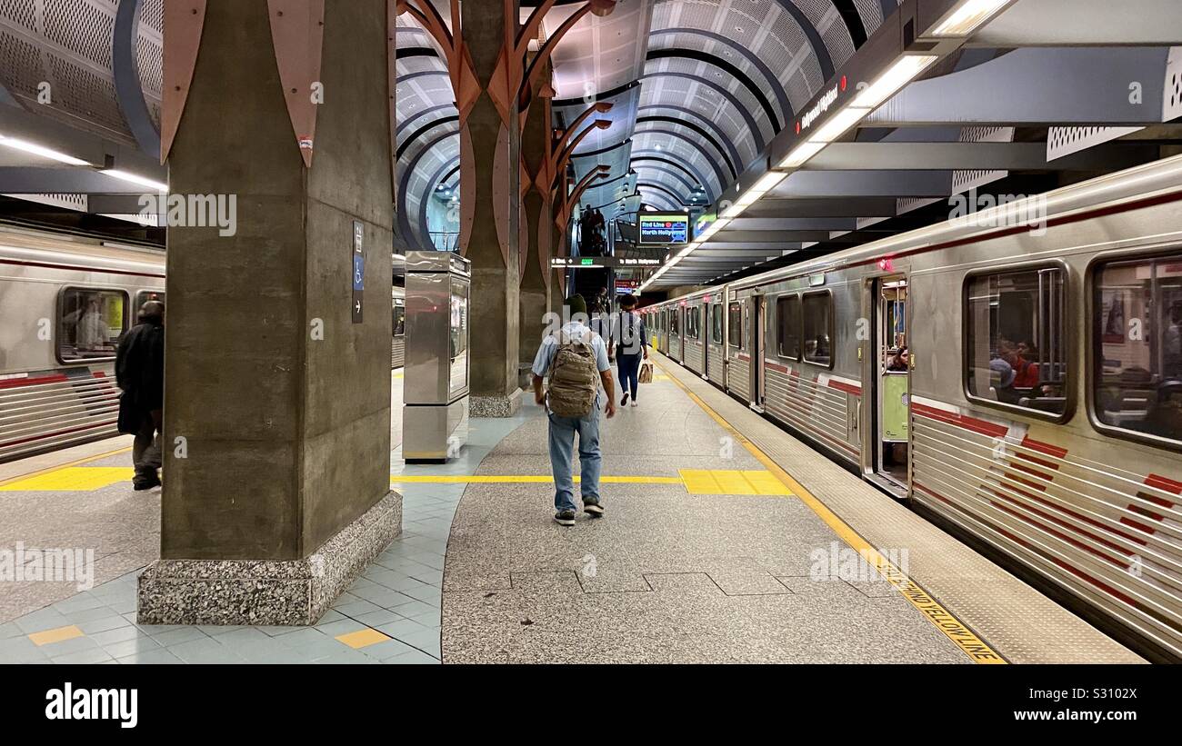 LOS ANGELES, CA, DEC 2019: passengers at Hollywood & Highland Red Line Station on the LA Metro, with trains on both sides of platform - Smartphone Captured Stock Image