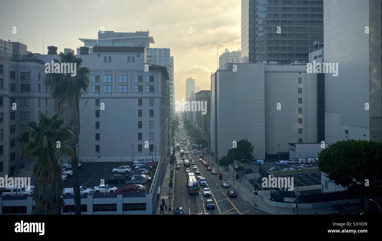 LOS ANGELES, CA, DEC 2019: high view looking down on traffic on Olive Street, near Bunker Hill in Downtown. Late afternoon with cityscape falling off into haze - Smartphone Captured Stock Image