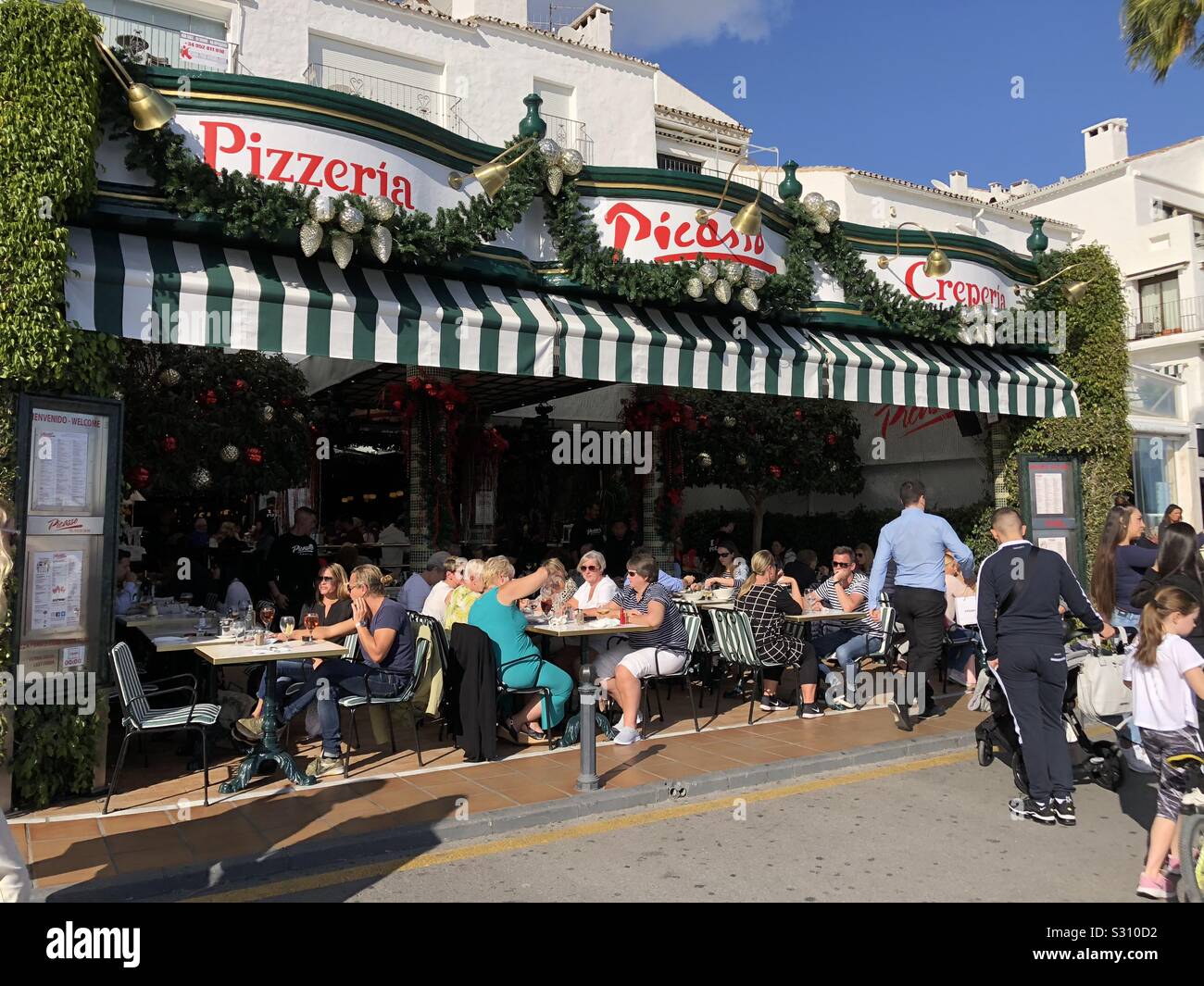 Diners in pizzeria Picasso in puerto Banus in Spain - Smartphone Captured Stock Image