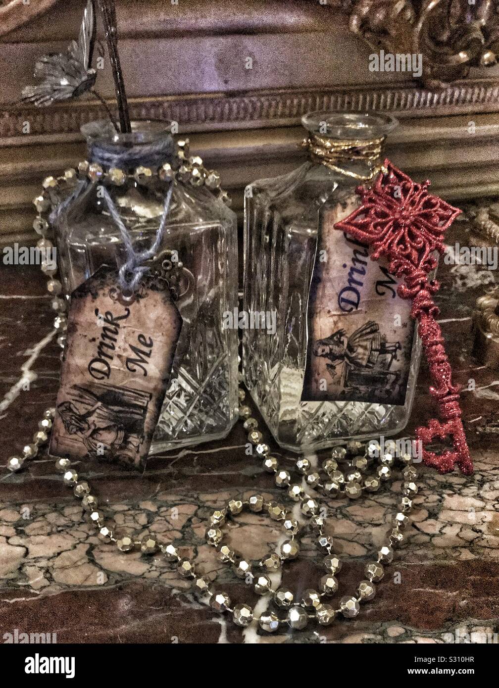 Alice in the Palace At Blenheim Palace 2019. Two bottles with Drink Me Labels a red key and a necklace - Smartphone Captured Stock Image