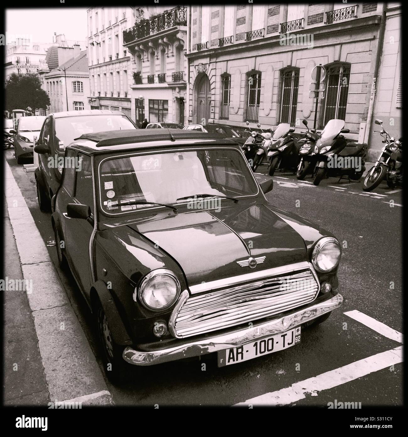 Classic Mini Cooper parked on a ninth arrondissement street in Paris, France - Smartphone Captured Stock Image