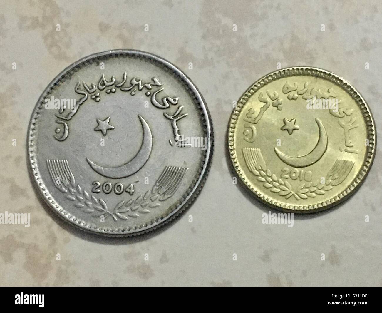 Tails sides of two Pakistani coins of five rupees value each Stock