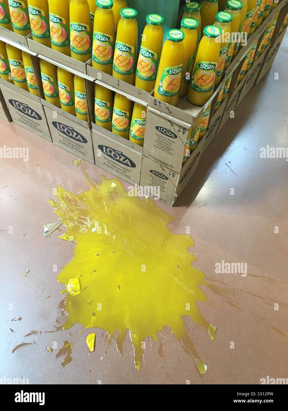 Broken bottle of juice at grocery store Stock Photo Alamy
