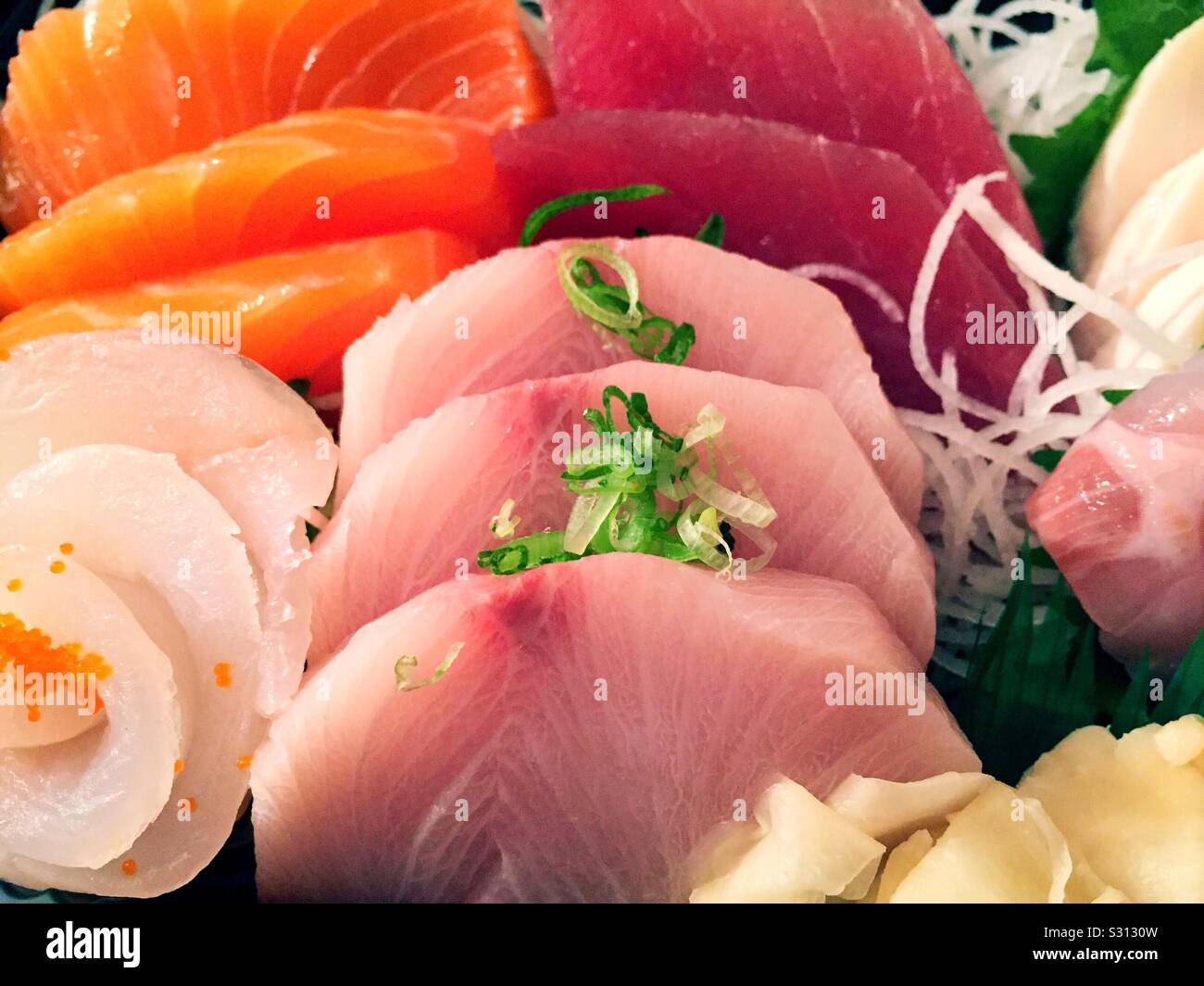 Close up of a Japanese sashimi meal featuring yellowtail and salmon