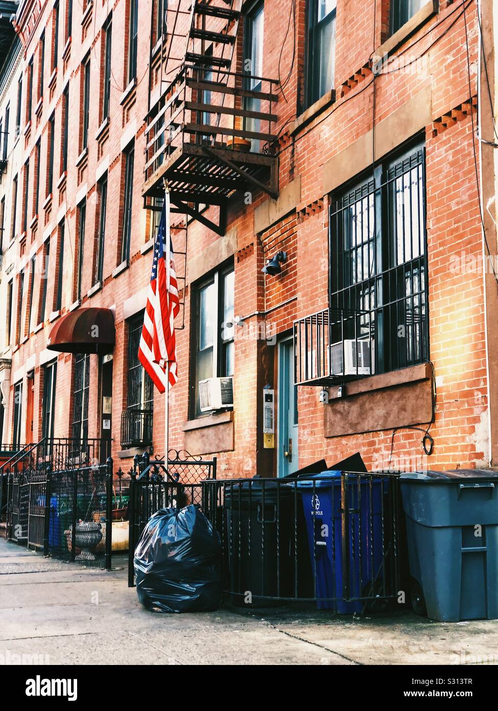 American flag at the entrance of a Brooklyn red brick building - Smartphone Captured Stock Image