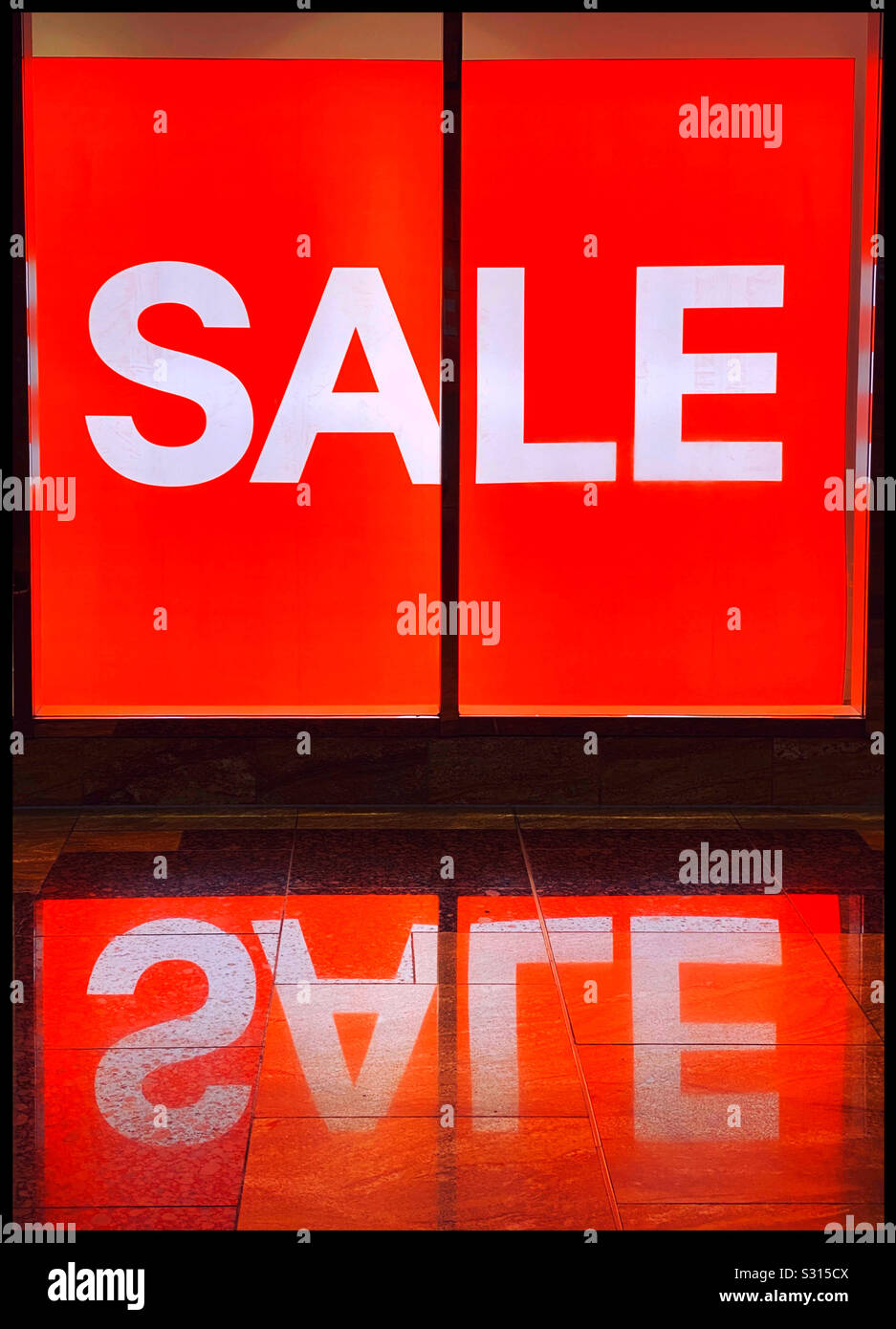 A massive “SALE” sign is lit up inside a large shop. It’s holiday season and time to go shopping for bargains! Retail therapy?! Photo © COLIN HOSKINS. - Smartphone Captured Stock Image