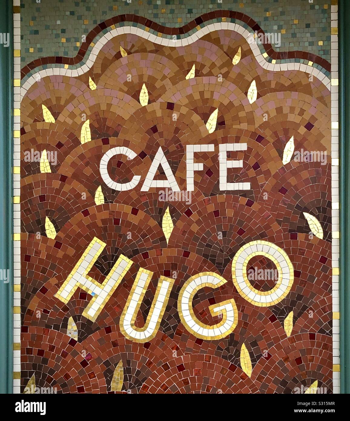 Famous cafe, bar, restaurant « Cafe Hugo » name made with mosaic - le Marais, Paris, France. Stock Photo