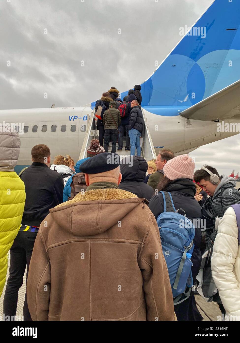 People boarding an airplane Stock Photo