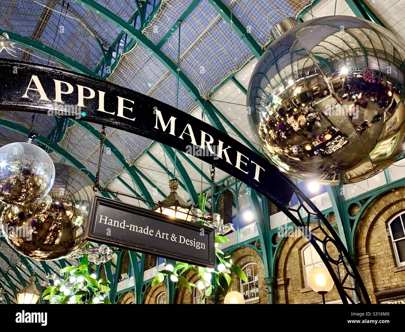 Covent Garden’s Apple market at Christmas with baubles and mistletoe - Smartphone Captured Stock Image