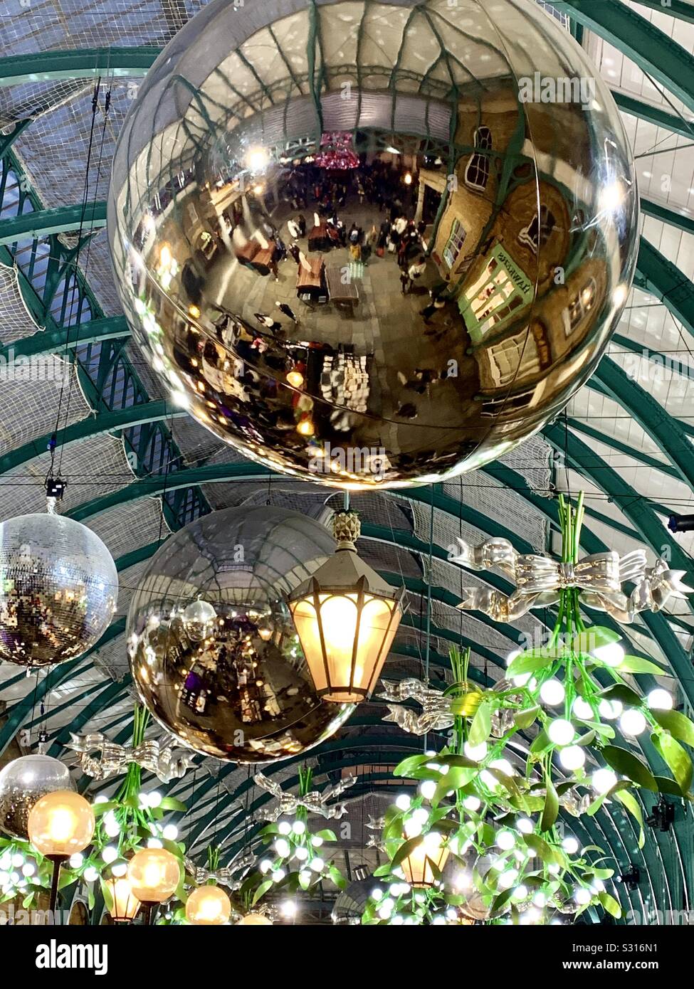 Giant baubles and mistletoe at London’s Covent Garden Christmas market - Smartphone Captured Stock Image
