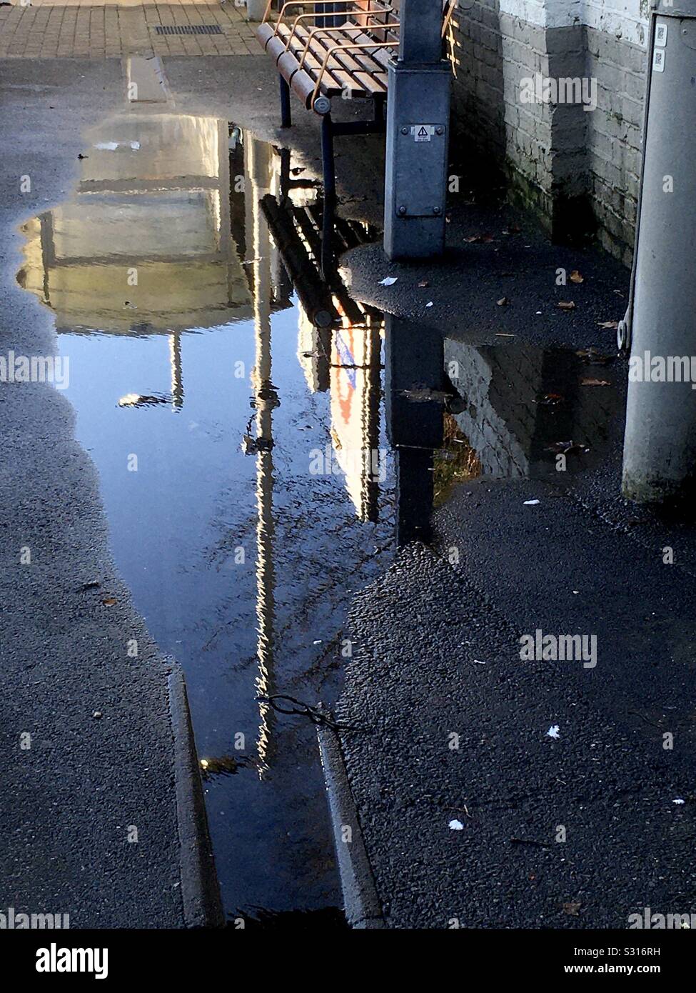 Waiting for the train. Reflection in a puddle on the platform. - Smartphone Captured Stock Image