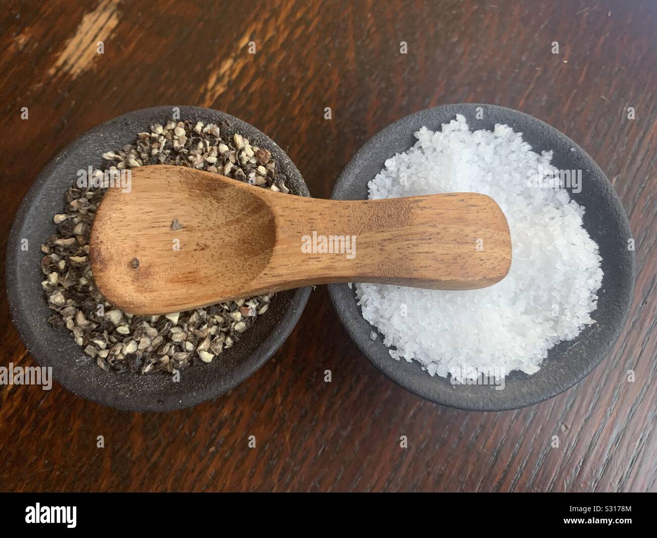 Salt and pepper in bowls Stock Photo Alamy